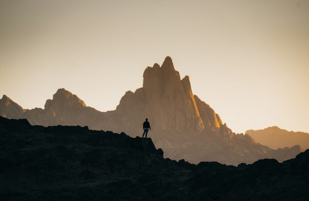 a person standing on top of a rocky hill
