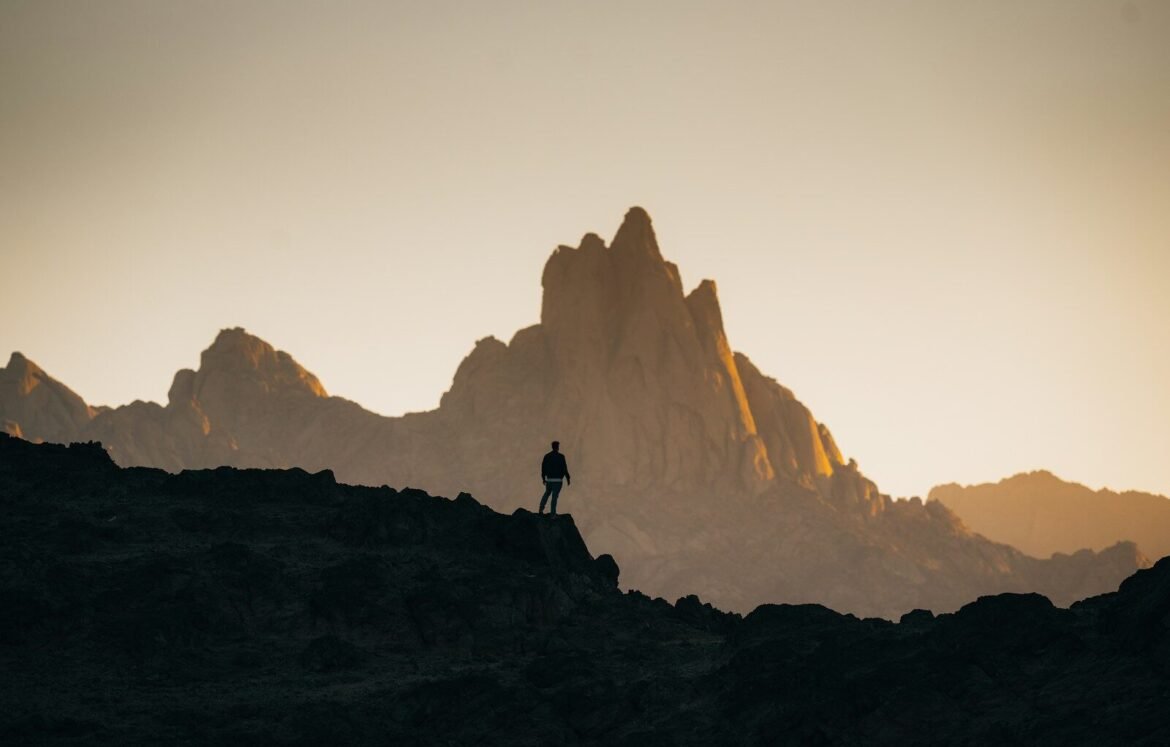 a person standing on top of a rocky hill