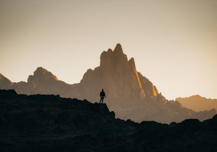 a person standing on top of a rocky hill