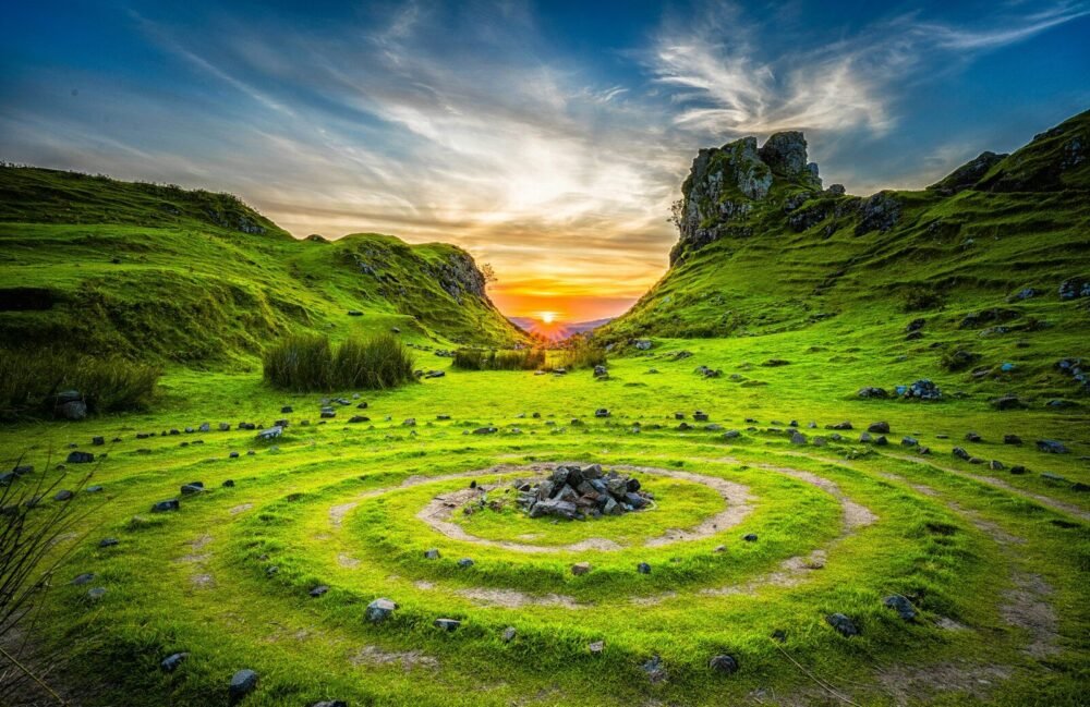 green grass field during sunset