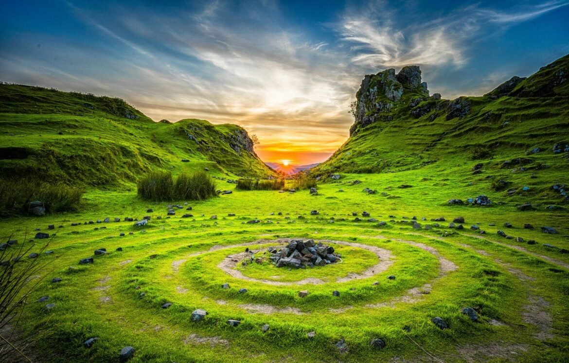 green grass field during sunset